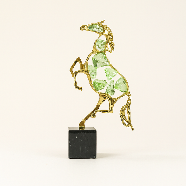Golden horse sculpture with green crystal accents, modern abstract design on a black marble base for luxury home decor table decoration item