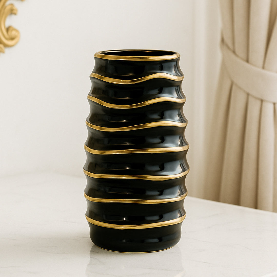 Modern black flower vase with gold accents, ideal for home and table decor.