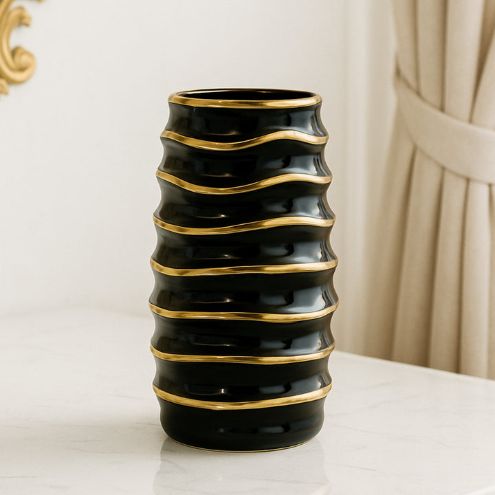 Modern black flower vase with gold accents, ideal for home and table decor.