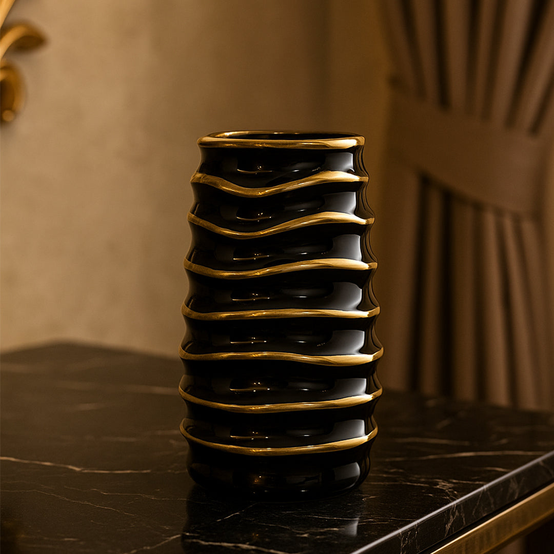 Rippled black and gold vase for contemporary living room or office decoration.