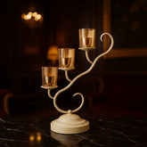 Elegant golden three-arm candle holder with glass votives, perfect for Diwali decoration and festive home decor by Divoma.